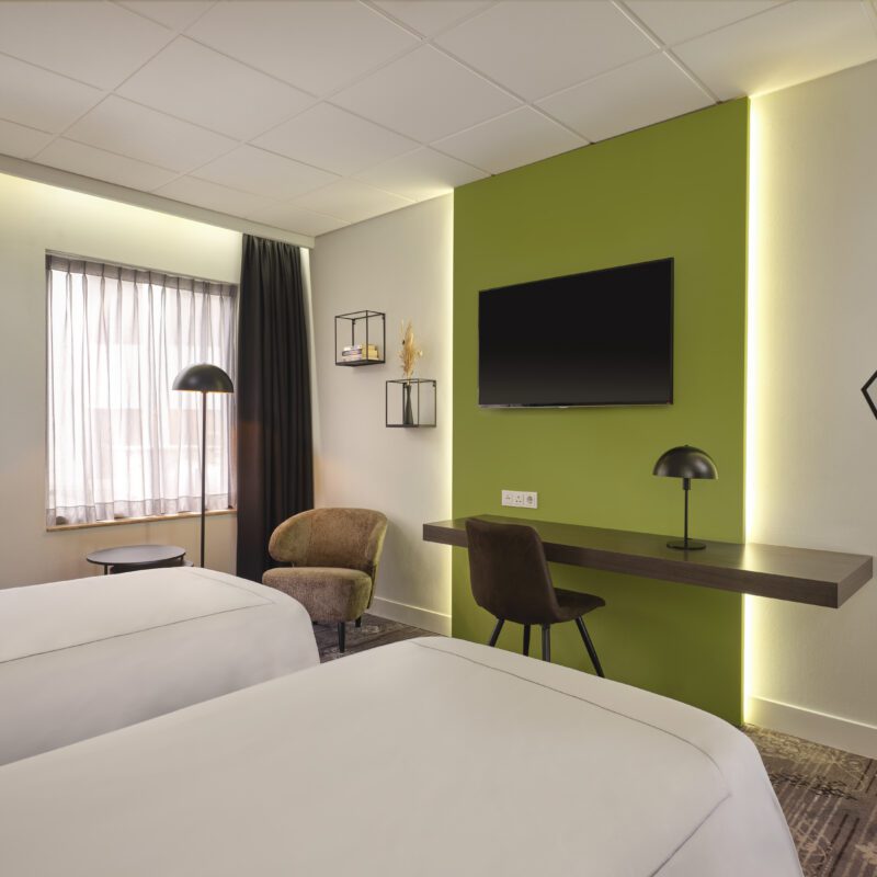 Park Plaza Eindhoven superior twin room lounge chair, desk, and TV